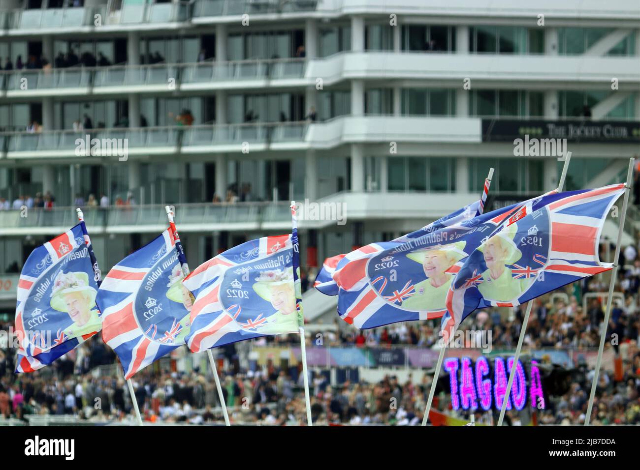 Epsom Downs, Surrey, England, UK. 3rd June, 2022. Flags flying in front of the Queen Elizabeth II Stand at Epsom Downs in Surrey, part of the Platinum Jubilee weekend celebrations for the 70 year reign of the British monarch. Credit: Julia Gavin/Alamy Live News Stock Photo