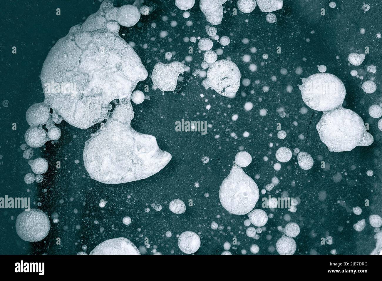Close-up of fat and oil spots on water surface, dirty pan with food leftover as background or texture Stock Photo