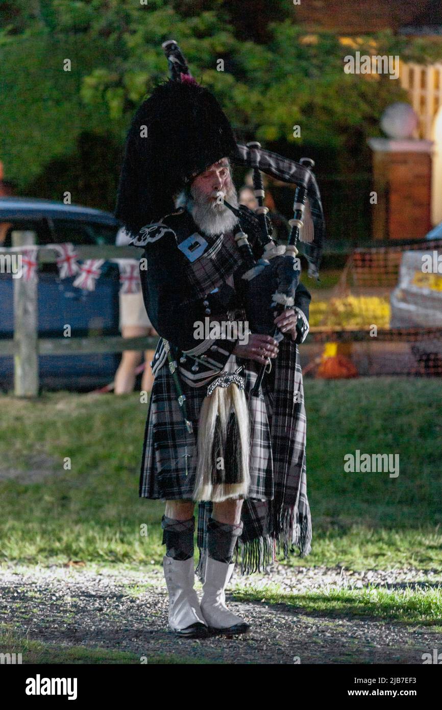 Local piper playing bagpipes during the Queen's Platinum Jubilee Stock