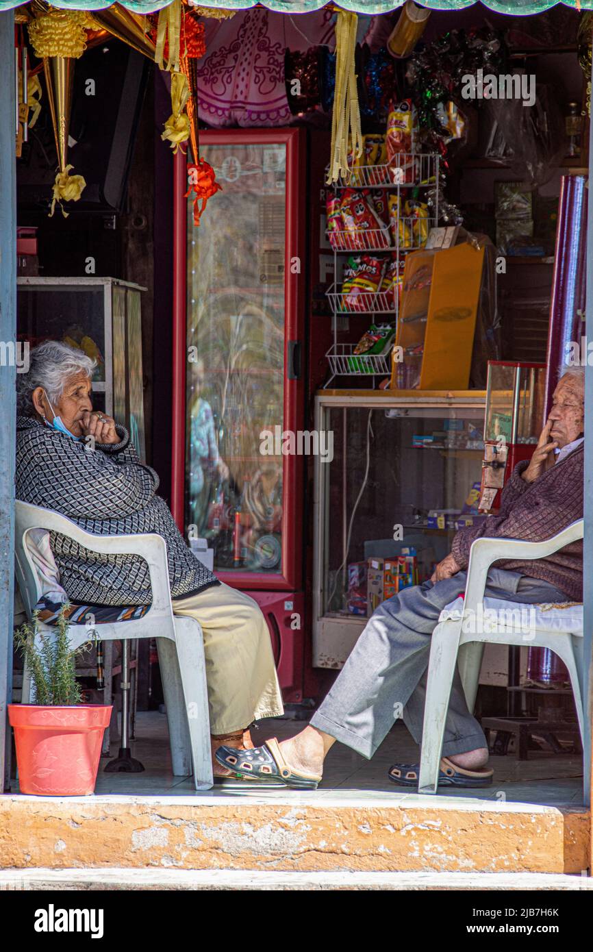 A married couple takes a break from their business to do some people watching, San Miguel de Allende, Mexico. Stock Photo