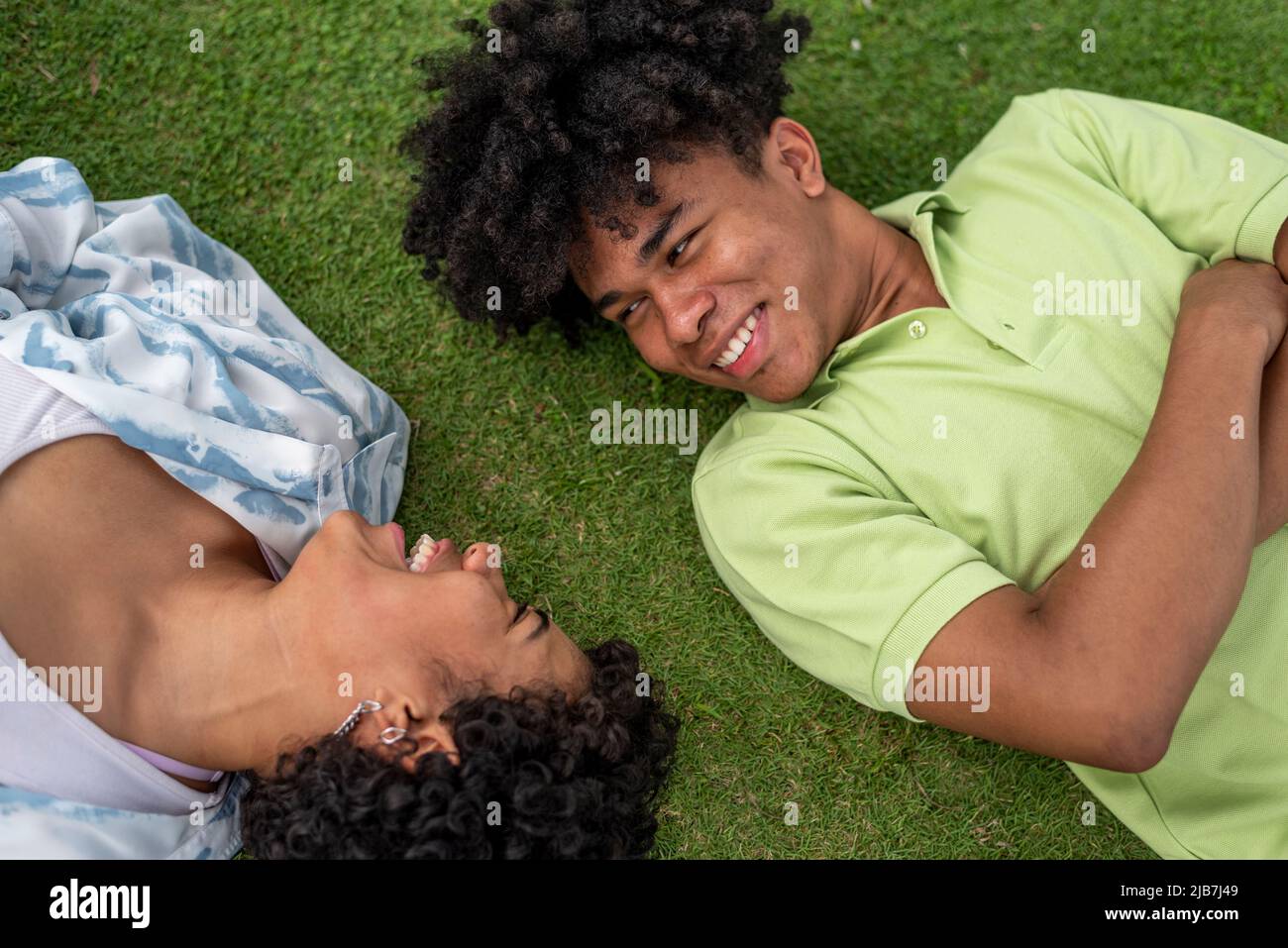 Latin couple lying on the grass - stock photo Stock Photo