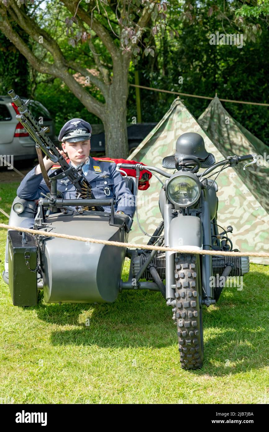 East Kirkby, Lincolnshire, UK – June 02 2022. World War 2 re-enactment – Male dressed up as a German officer in the sidecar of a military motorcycle a Stock Photo