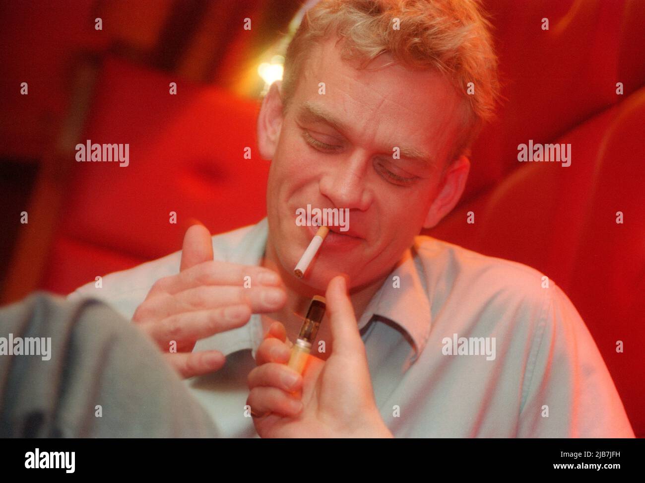 male lighting a cigarette with a zippo lighter Stock Photo