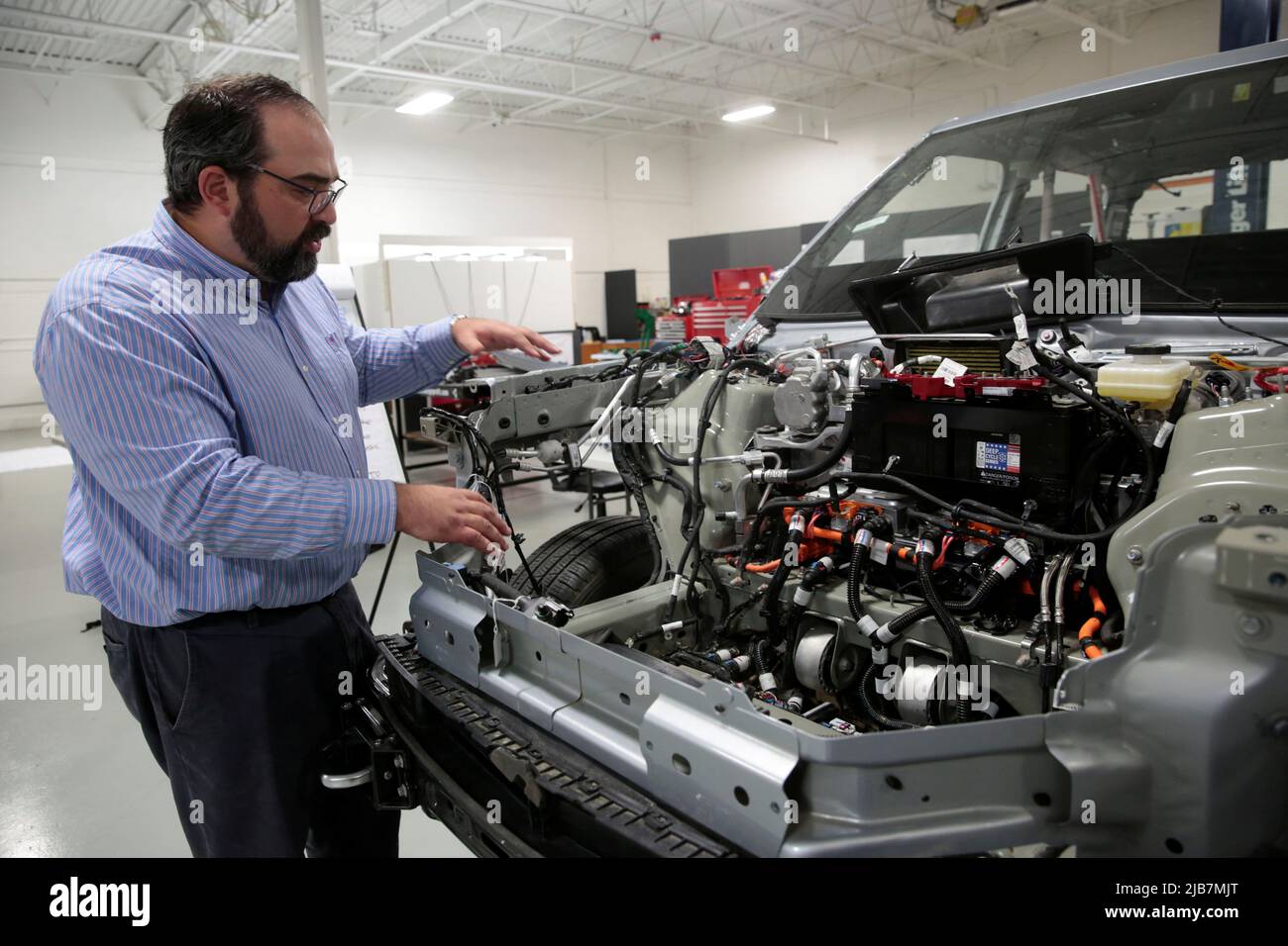Munro & Associates Director Ben Lindamood shows a partially dismantled Rivian R1T electric truck during its teardown at the Munro headquarters in Auburn Hills, Michigan, U.S., June 3, 2022.  REUTERS/Rebecca Cook Stock Photo