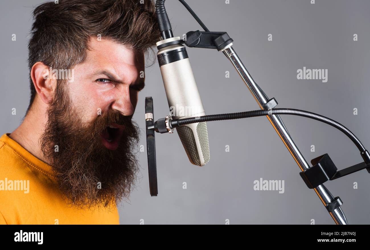 Studio records. Bearded man singing in condenser microphone. Professional  vocalist. Karaoke singer Stock Photo - Alamy