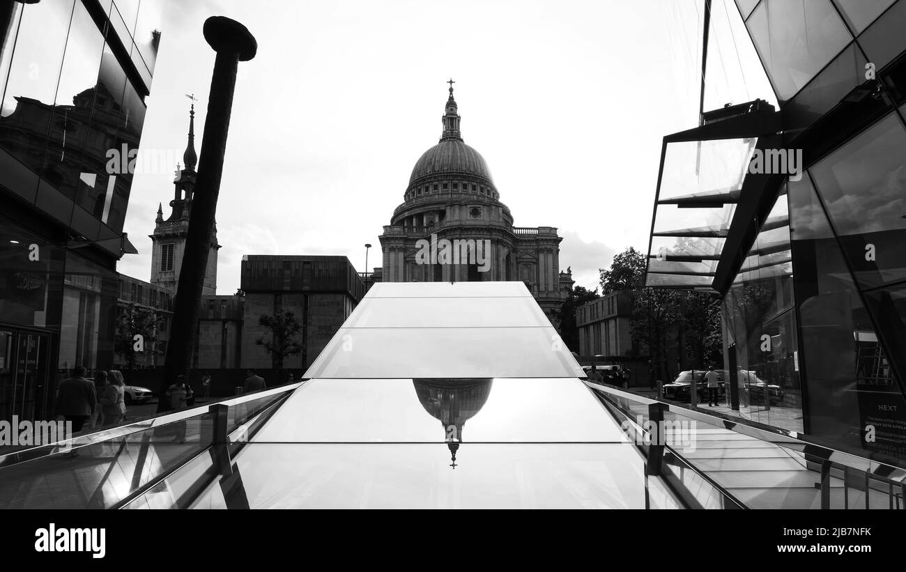 London, Greater London, England, May 21 2022: View from One New Change floor level towards St Pauls Cathedral partly reflected in the glass foreground Stock Photo