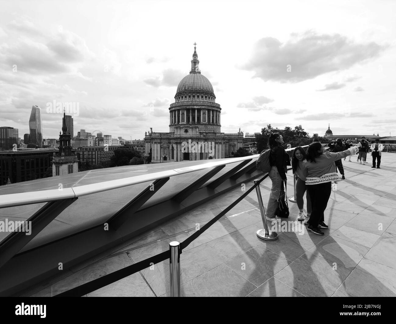 London, Greater London, England, May 21 2022: View from One New Change towards St Pauls Cathedral as a group of women have fun taking e a selfie. Stock Photo