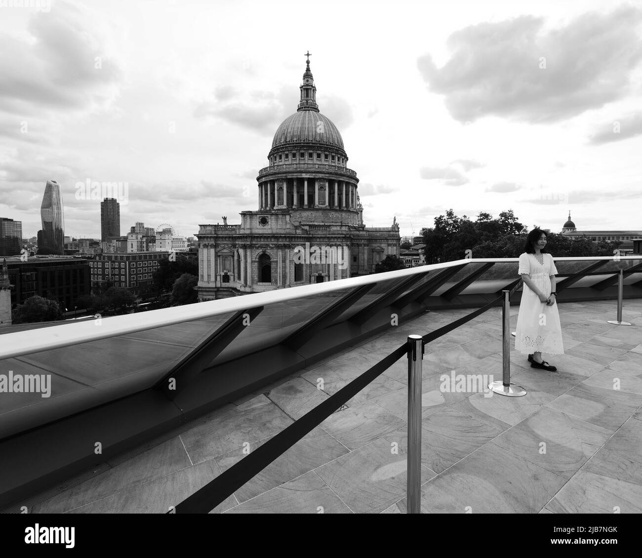 London, Greater London, England, May 21 2022: View from One New Change towards St Pauls Cathedral. An Asian lady in a white dress poses for a photo. Stock Photo