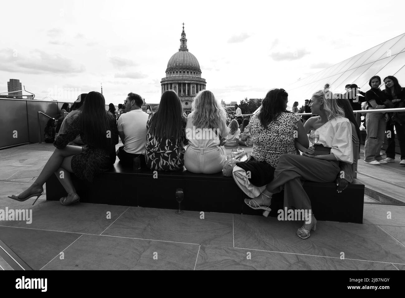 London, Greater London, England, May 21 2022: View from One New Change. A group of friends sit and relax taking in the view of St Pauls Cathedral. Stock Photo