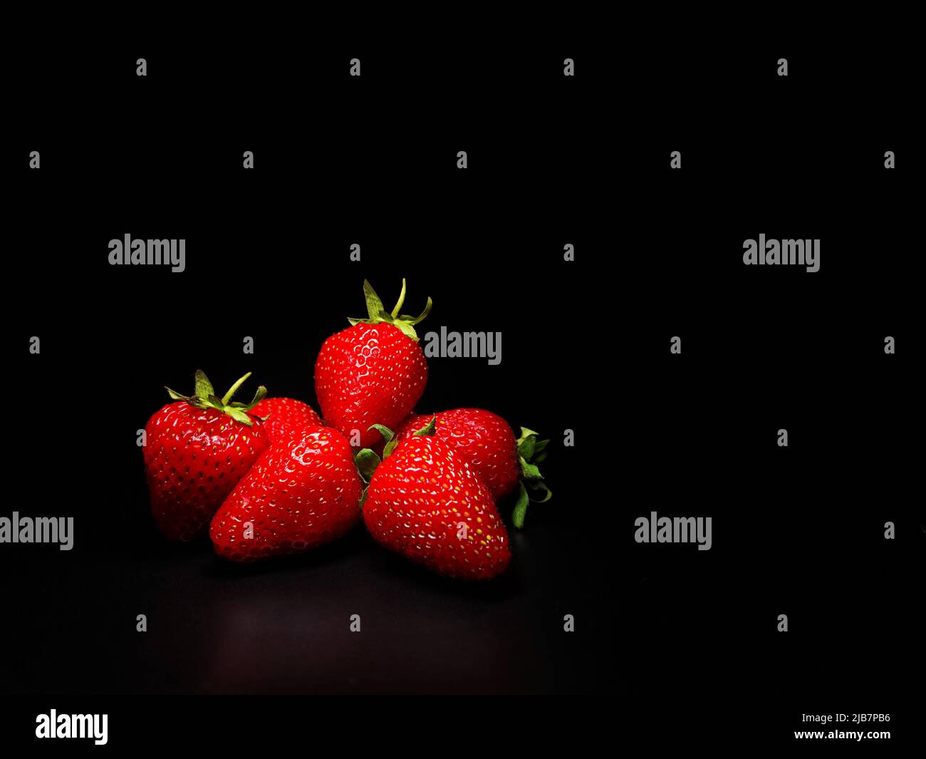 Strawberries on a black background. Isolate Stock Photo - Alamy