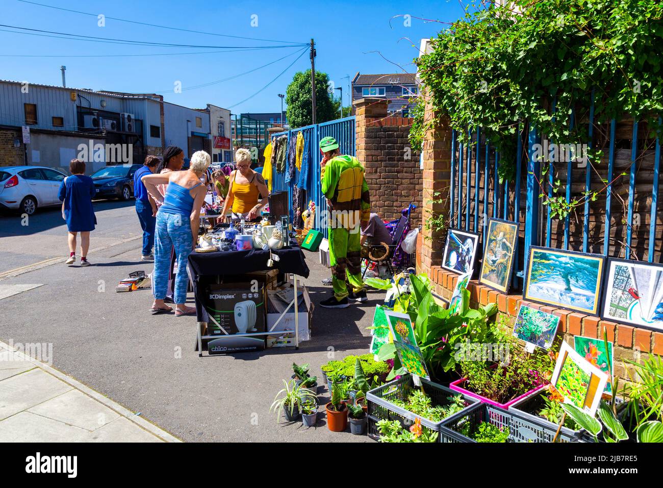 People shopping at a stall during a local community Jumble Trail in Forest Gate, Newham, London, UK Stock Photo