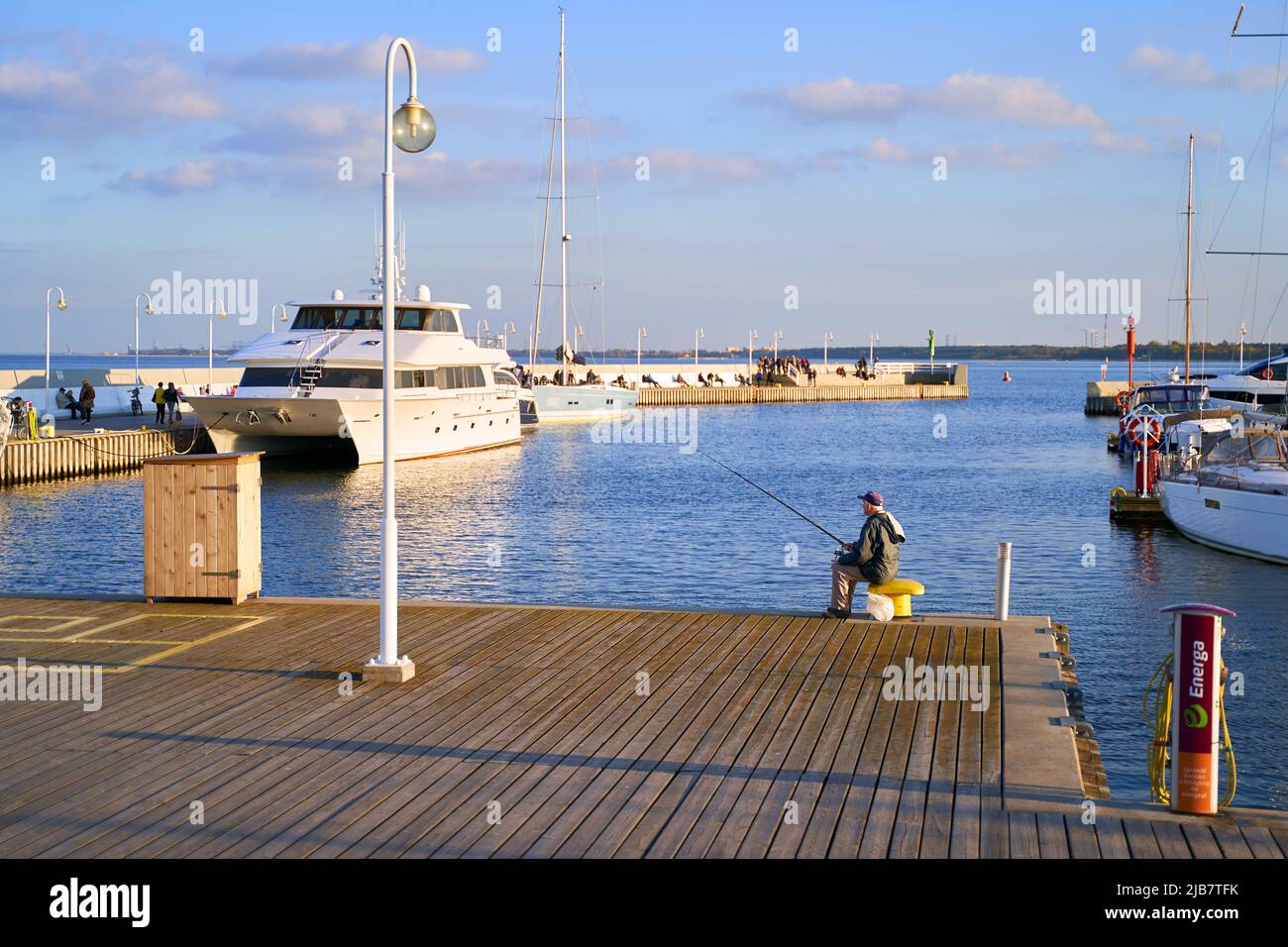 Sopot, Poland, Oct 5, 2018: Old man fishing with a rod at the Sopot Pier aka Molo Stock Photo