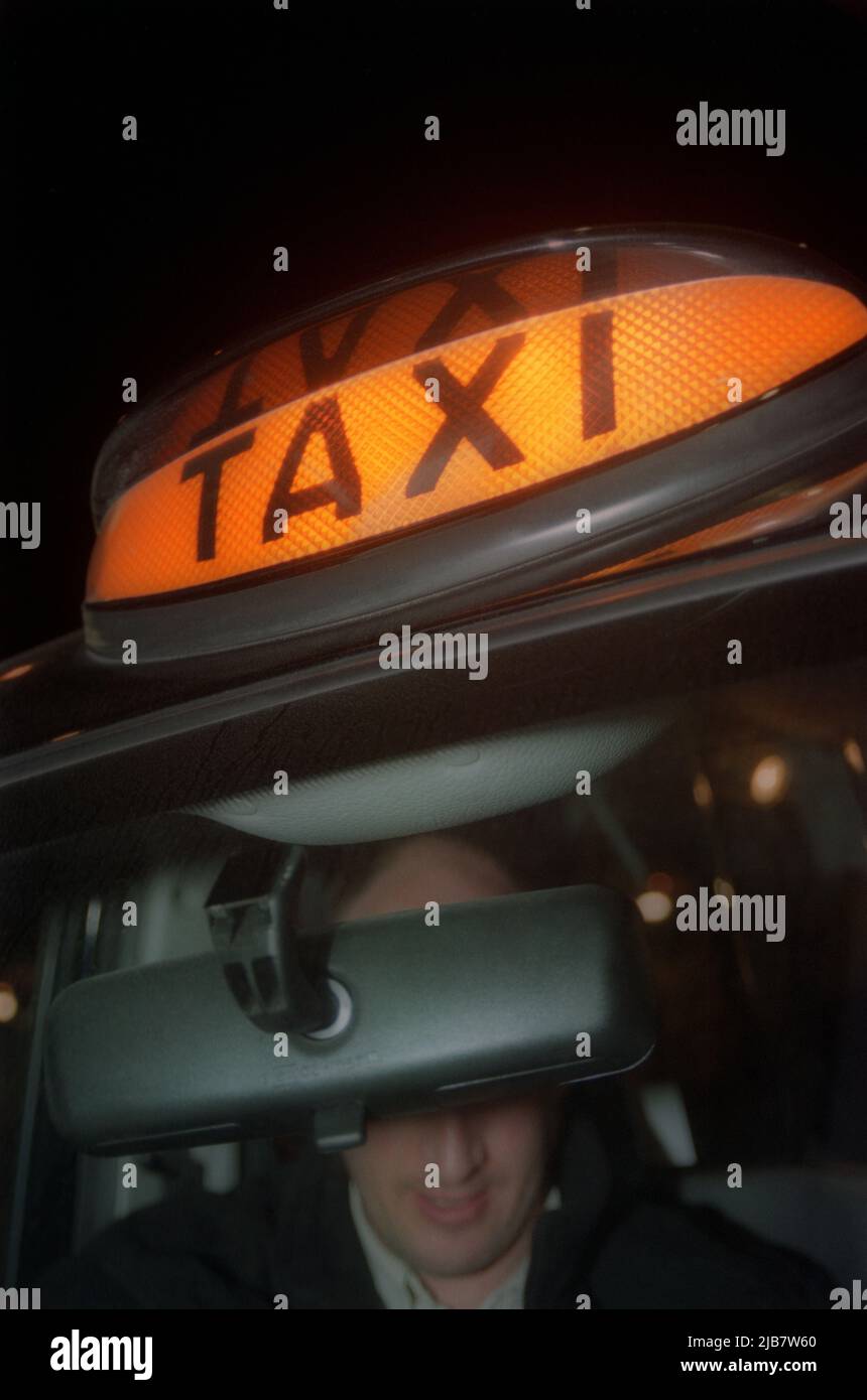 Hackney carriage taxi sign and taxi driver Stock Photo