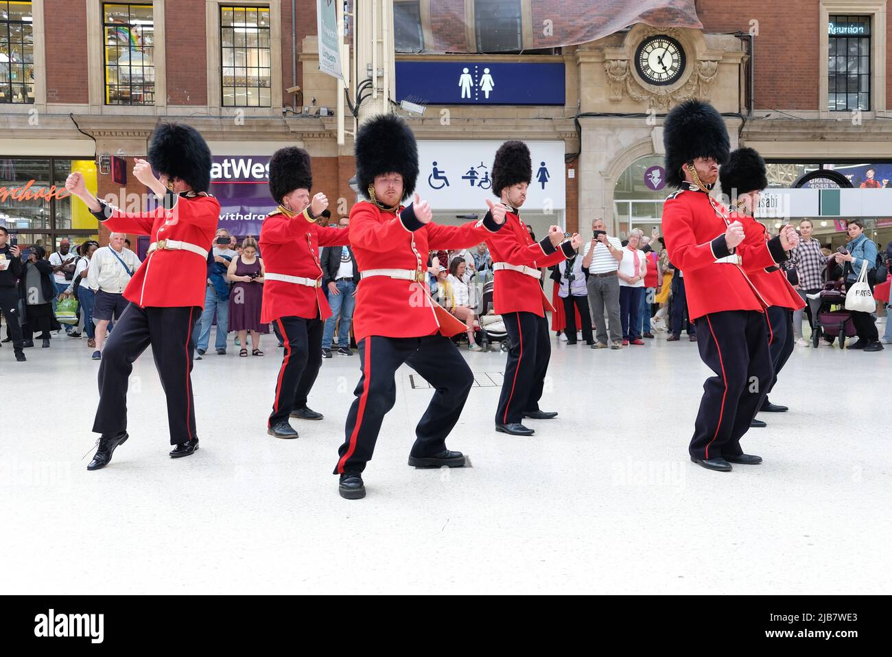 London, UK. 3rd June, 2022. A flashmob, dressed-up as the Queen's Guards entertained members of the public at Victoria Railway Station during the Jubilee Bank Holiday. The dancers performed to a variety of well-known pop songs, including Gangnam Style, YMCA and Single Ladies by Beyonce. Credit: Eleventh Hour Photography/Alamy Live News Stock Photo