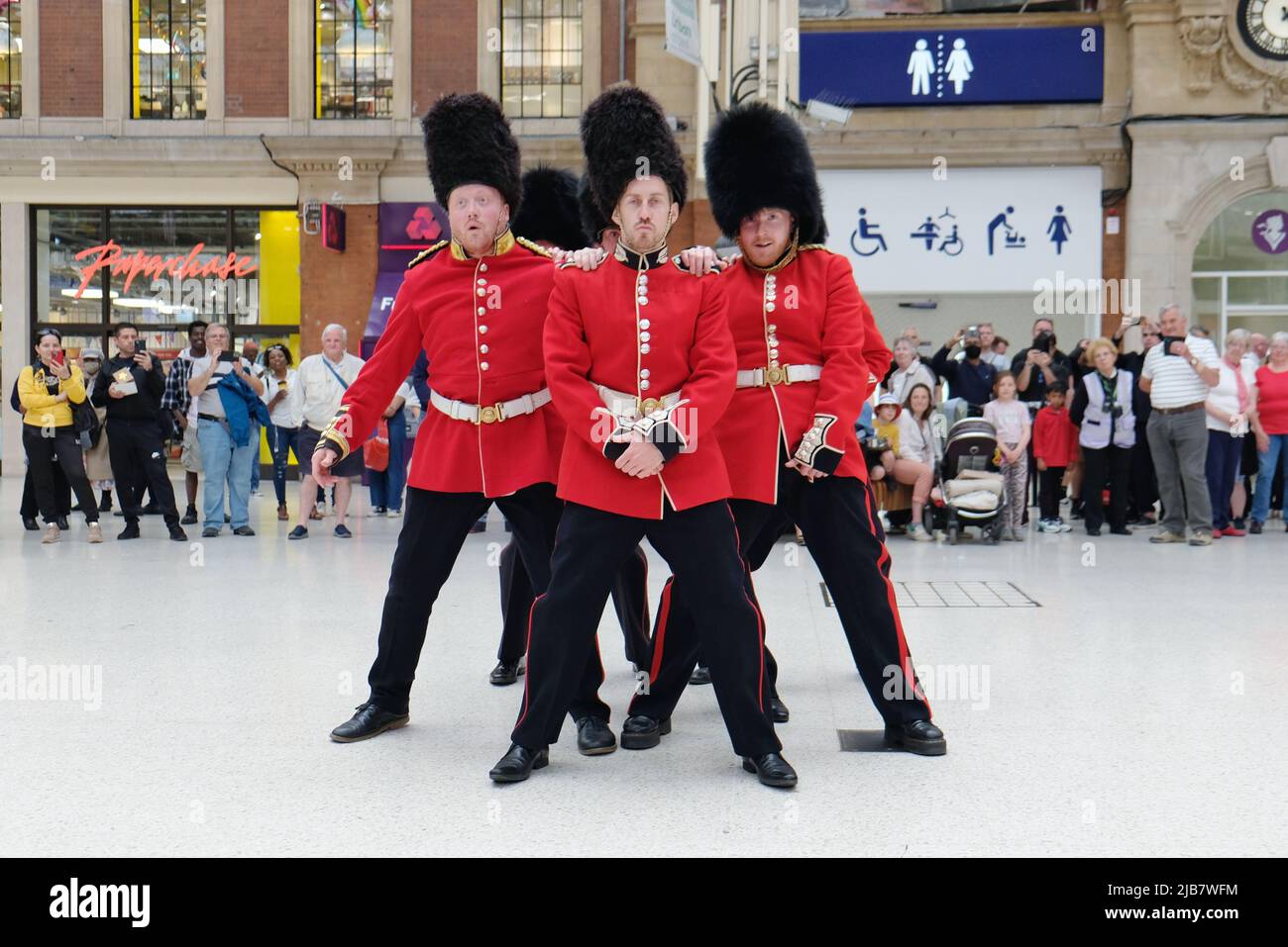 London, UK. 3rd June, 2022. A flashmob, dressed-up as the Queen's Guards entertained members of the public at Victoria Railway Station during the Jubilee Bank Holiday. The dancers performed to a variety of well-known pop songs, including Gangnam Style, YMCA and Single Ladies by Beyonce. Credit: Eleventh Hour Photography/Alamy Live News Stock Photo