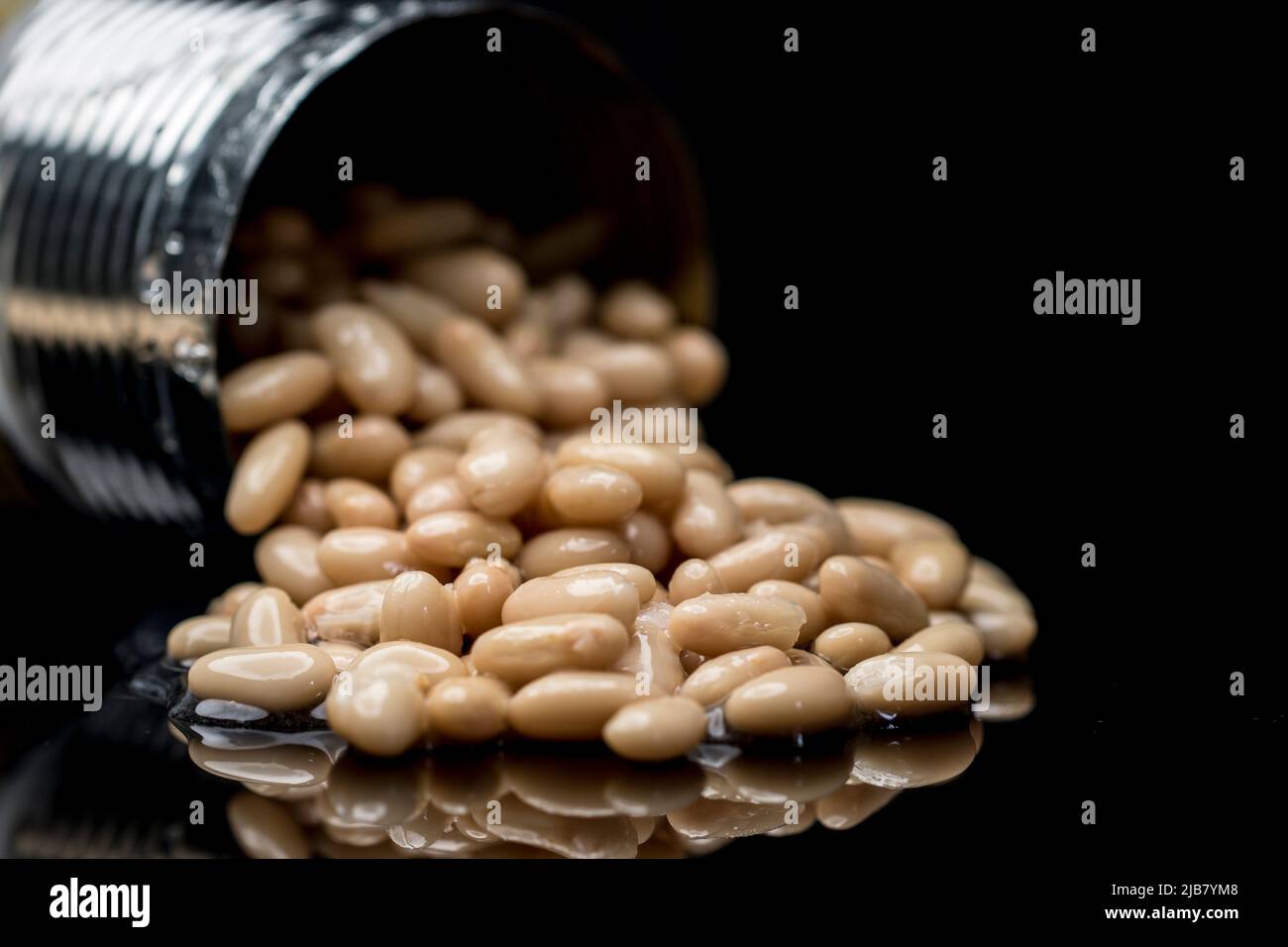 Wasted food spilled beans from a can. Food supplies expired. Stock Photo