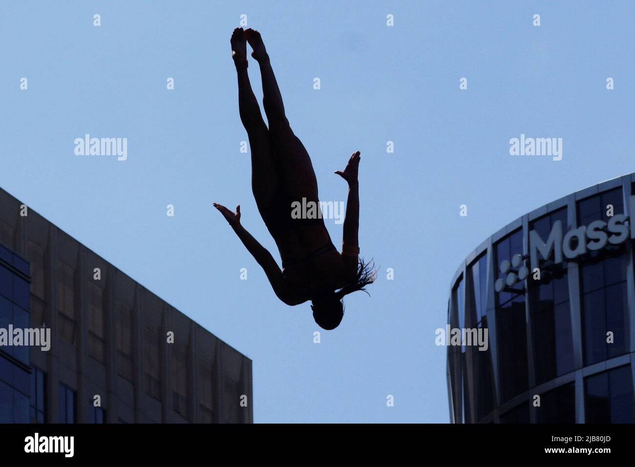 Maria Paula Quintero of Colombia dives off the roof of the Institute of Contemporary Art while competing at the Red Bull Cliff Diving World Series in Boston, Massachusetts, U.S., June 3, 2022.   REUTERS/Brian Snyder Stock Photo