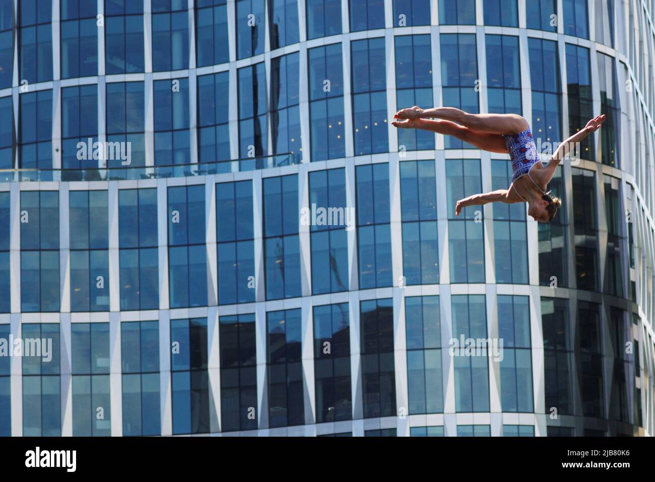 Iris Schmidbauer of Germany dives off the roof of the Institute of Contemporary Art while competing at the Red Bull Cliff Diving World Series in Boston, Massachusetts, U.S., June 3, 2022.   REUTERS/Brian Snyder Stock Photo