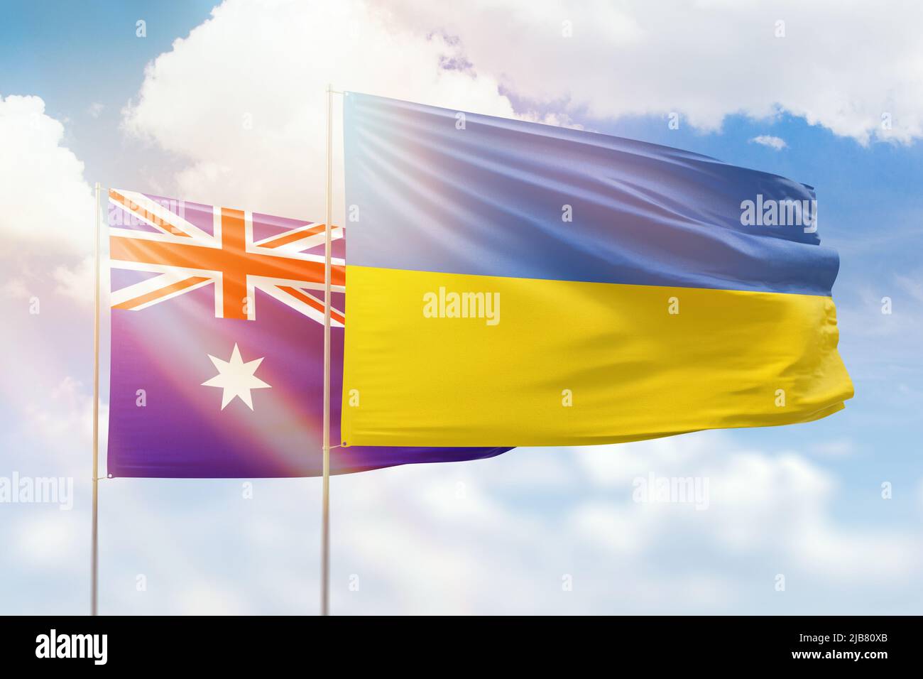 Sunny blue sky and flags of ukraine and australia Stock Photo
