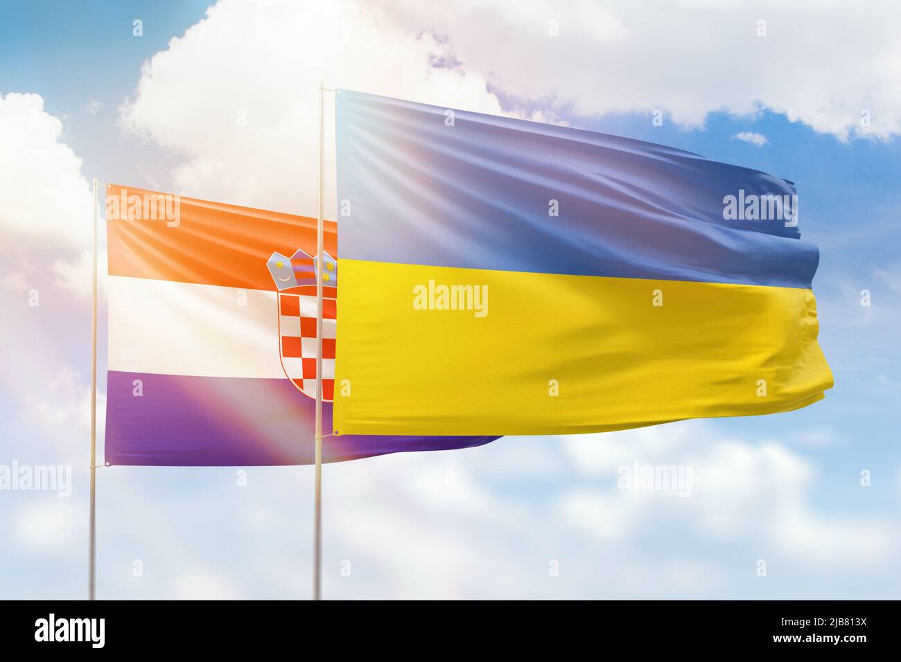Sunny blue sky and flags of ukraine and croatia Stock Photo