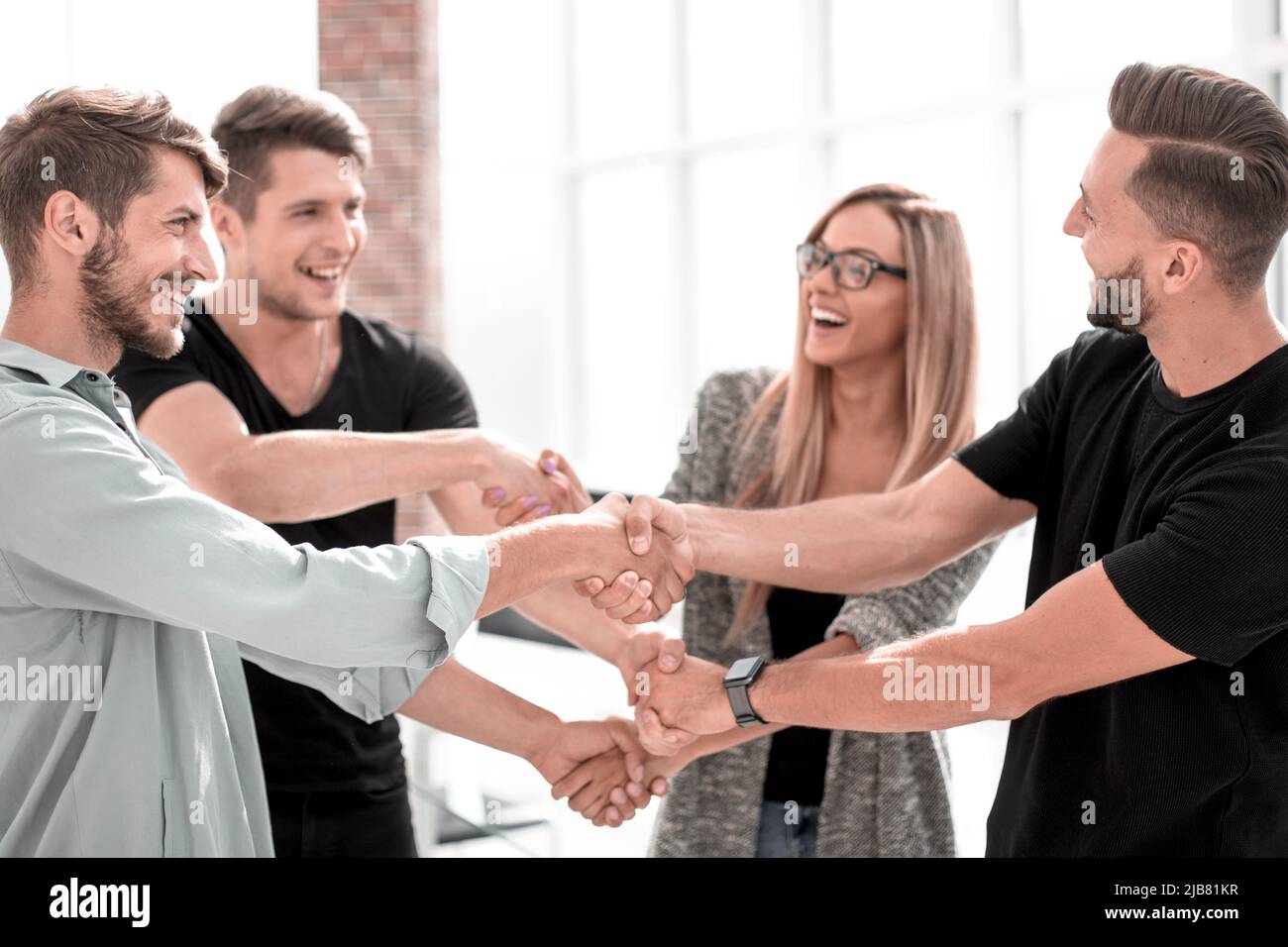 Happy smiling business team standing in a row at office Stock Photo - Alamy