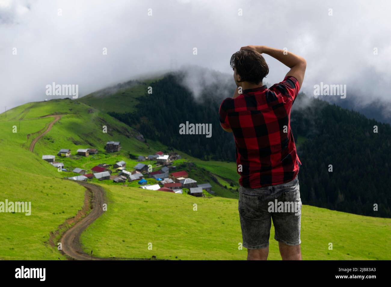 Karadeniz Rize Turkey Rize, Turkey - July 2016: Young man taking pictures with camera on high ...