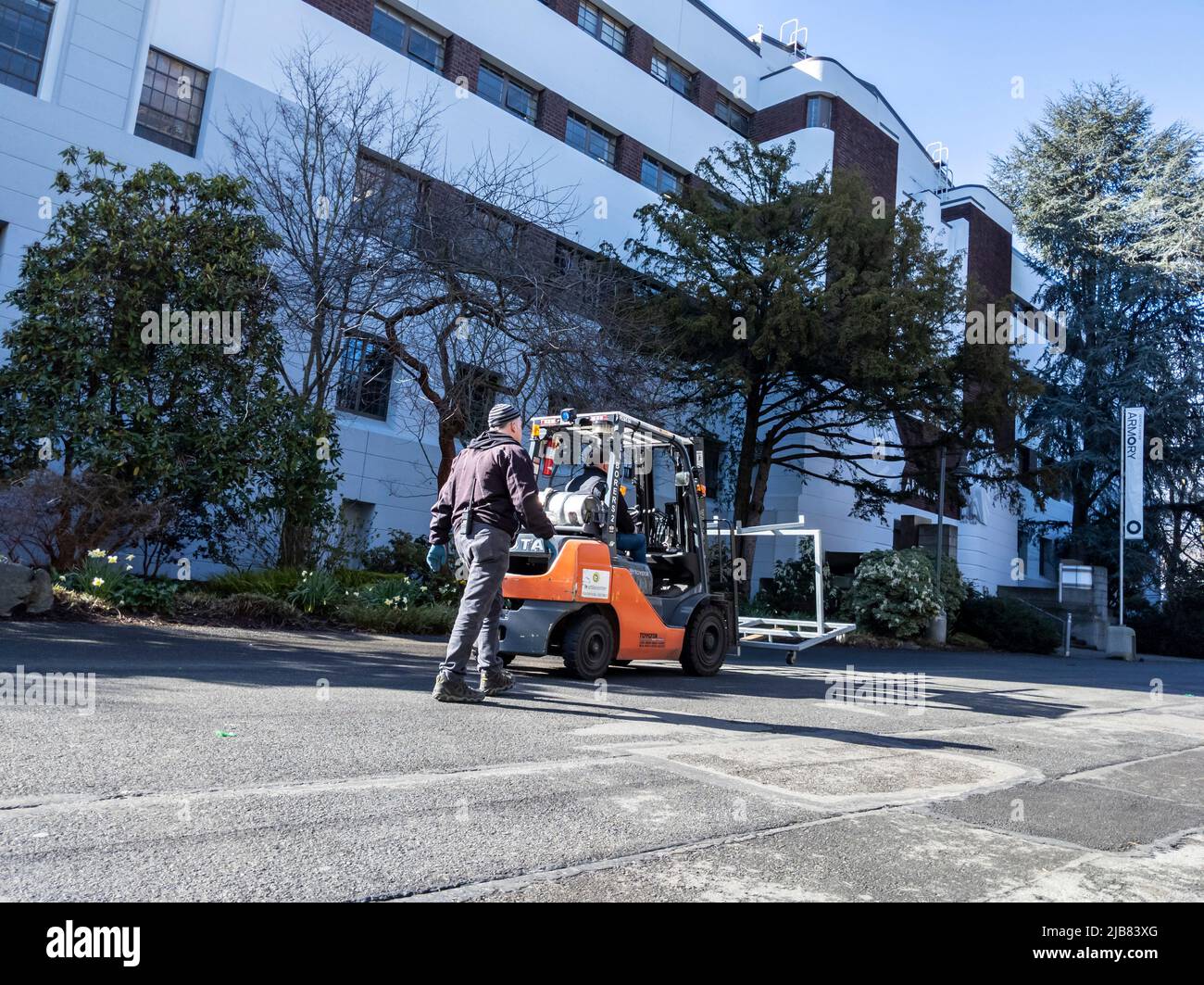 Seattle, WA USA - circa March 2022: View of an orange Toyota work truck clearing metal block-off gates after a marathon race downtown. Stock Photo