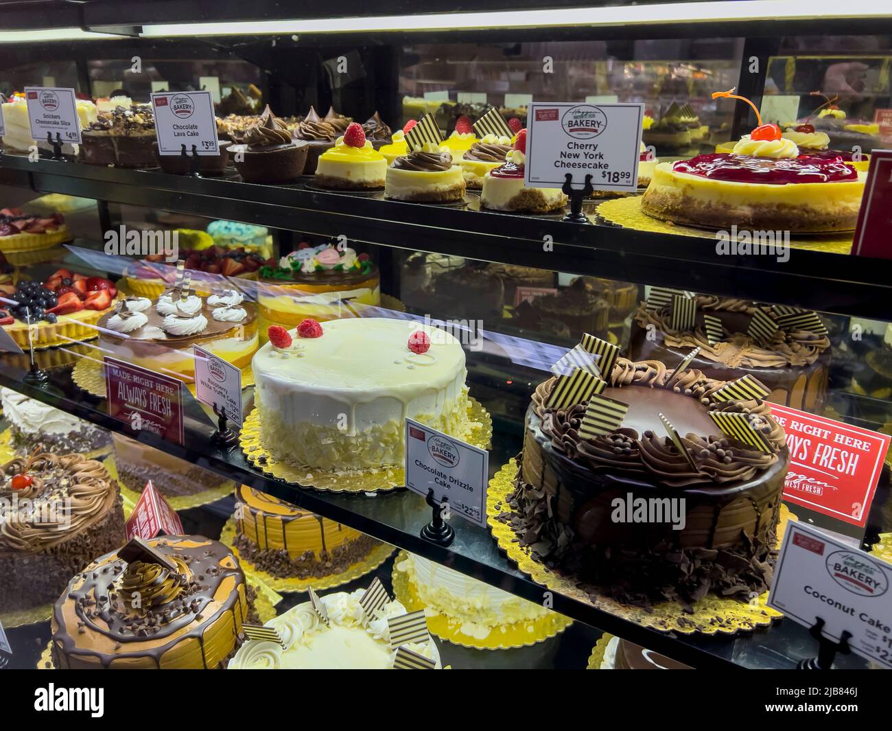 Woodinville, WA USA - circa May 2022: Angled view of various cakes for sale inside the bakery department at Haggen grocery store. Stock Photo