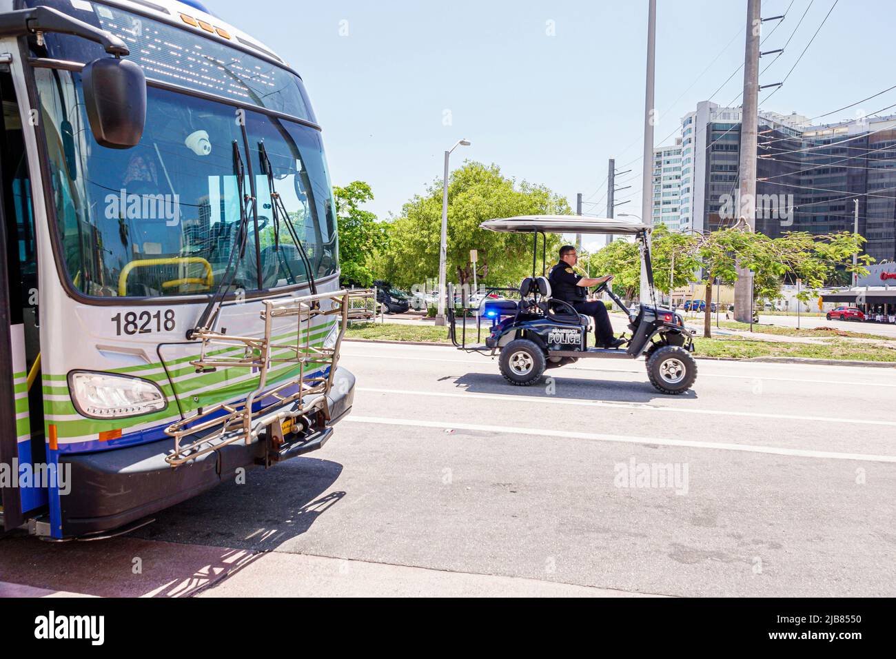 Miami Beach Florida,Miami-Dade Metrobus public transportation bus,police electric cart vehicle ATV Stock Photo