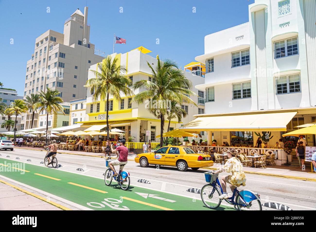 Miami Beach Florida,Ocean Drive bike lane riding bikes bicycles citibike bike sharing,hotels taxicab Art Deco District Stock Photo