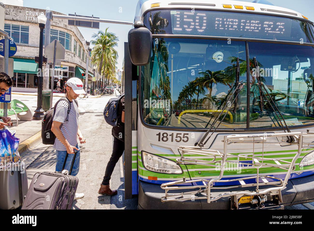 Miami Beach Florida,Miami-Dade Metrobus Route 150 Airport Flyer bus public transportation,passengers riders boarding luggage Stock Photo