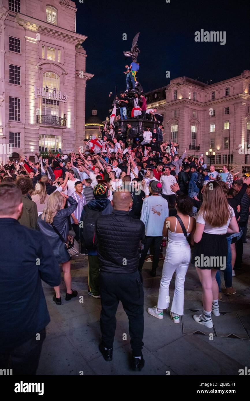 England football fans celebrate in Piccadilly Circus after their win in the Euro's against