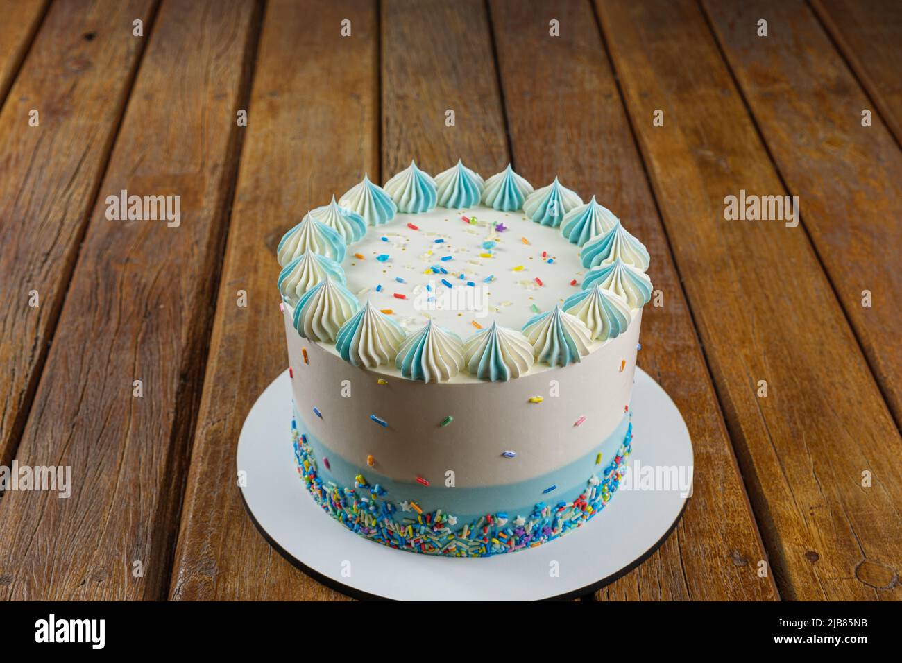 Vanilla cake with butter cream frosting in the shape of zefir. Stock Photo