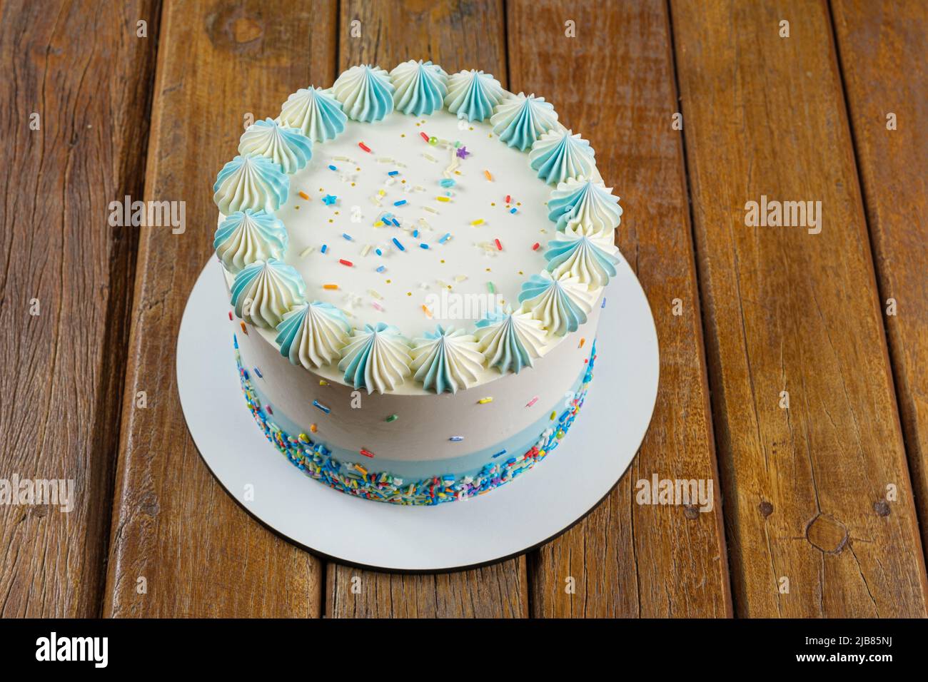 Vanilla cake with butter cream frosting in the shape of zefir top view. Stock Photo