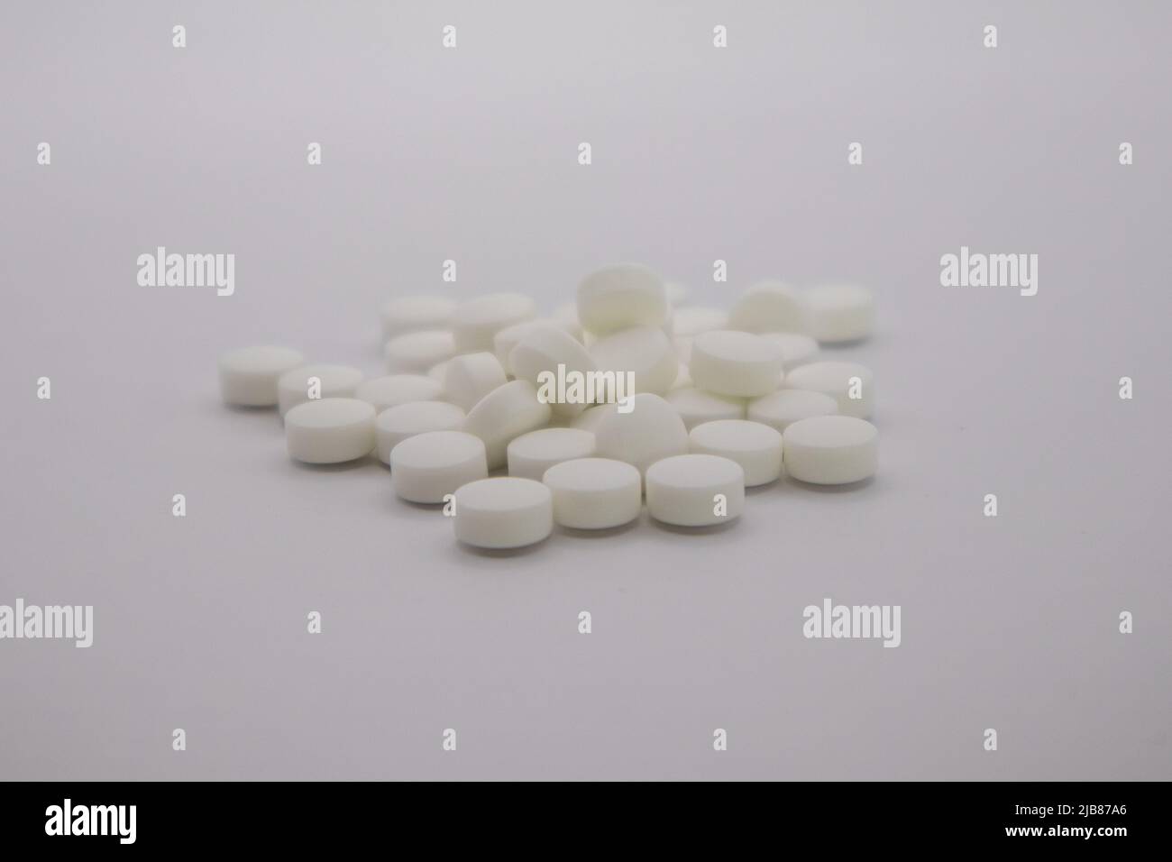 Pile of white pills on neutral background. Bupropion.  Stock Photo