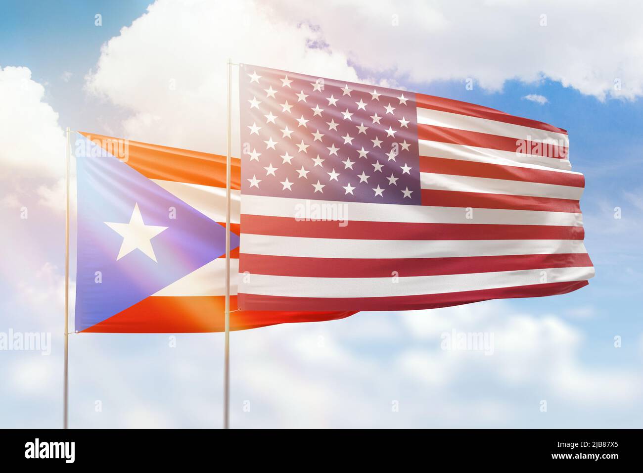 Sunny blue sky and flags of united states of america and puerto rico