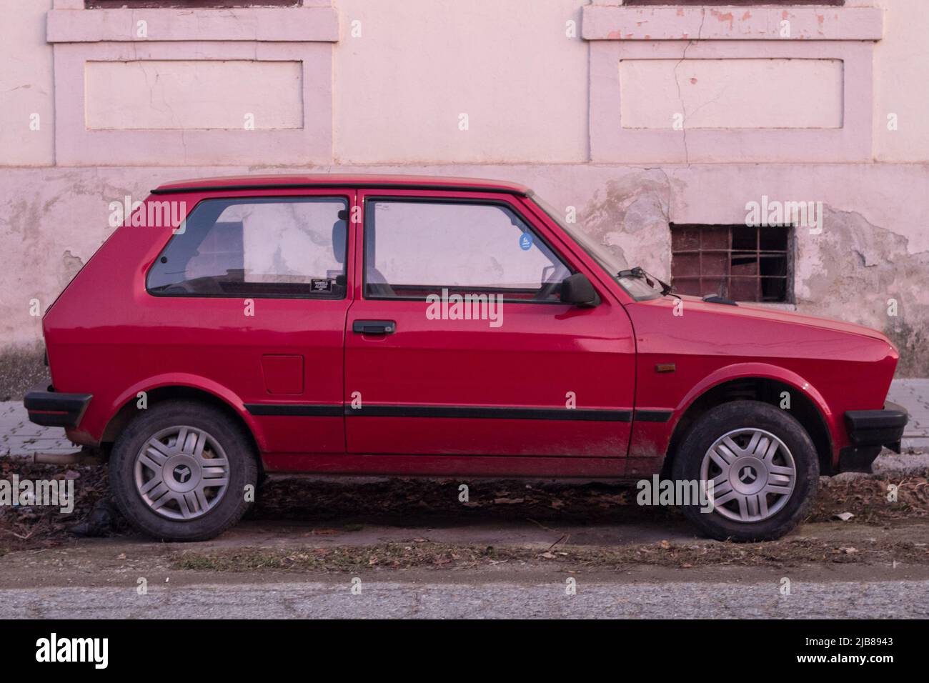 Picture of a Zastava car, red colors, branded as Zastava 45 parked in a car park of Vrsac Serbia. The Yugo also marketed as the Zastava Koral and Yugo Stock Photo