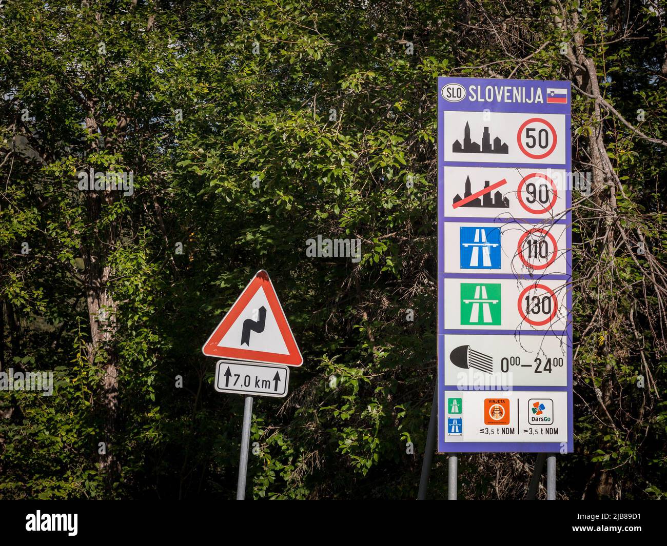 Picture of a road sign indicating the various speed limits applicable by law in slovenia, taken on a road at the slovenian border. Stock Photo