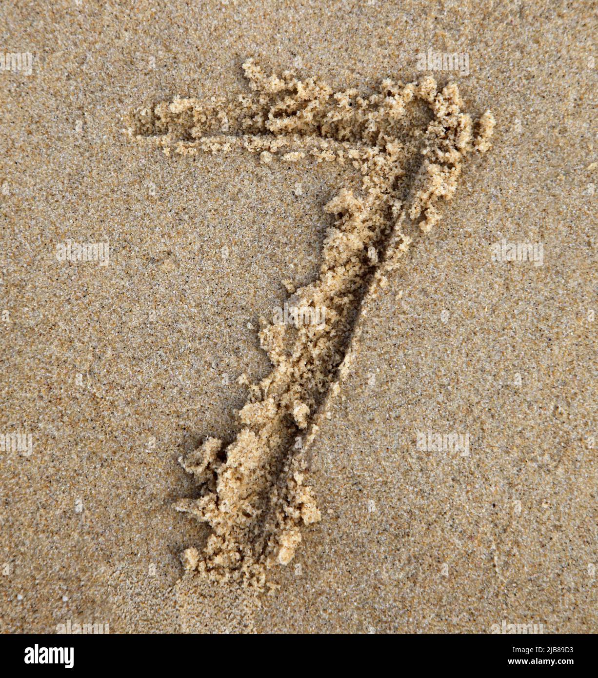 Seven written in the sand at the beach Stock Photo