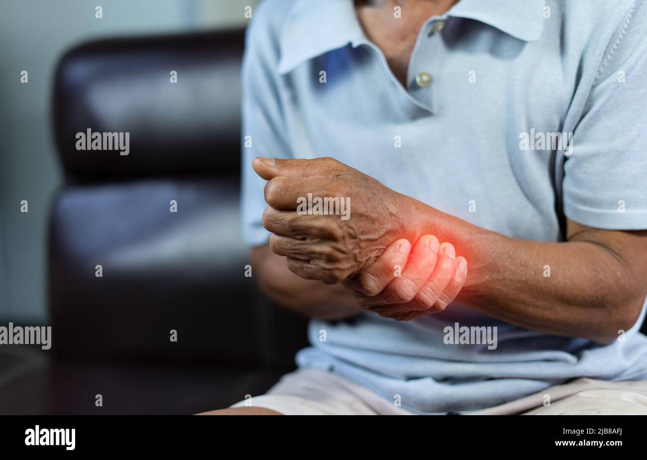 Closeup of senior hands with hand pain in palm and massage his self, Health problem. Stock Photo