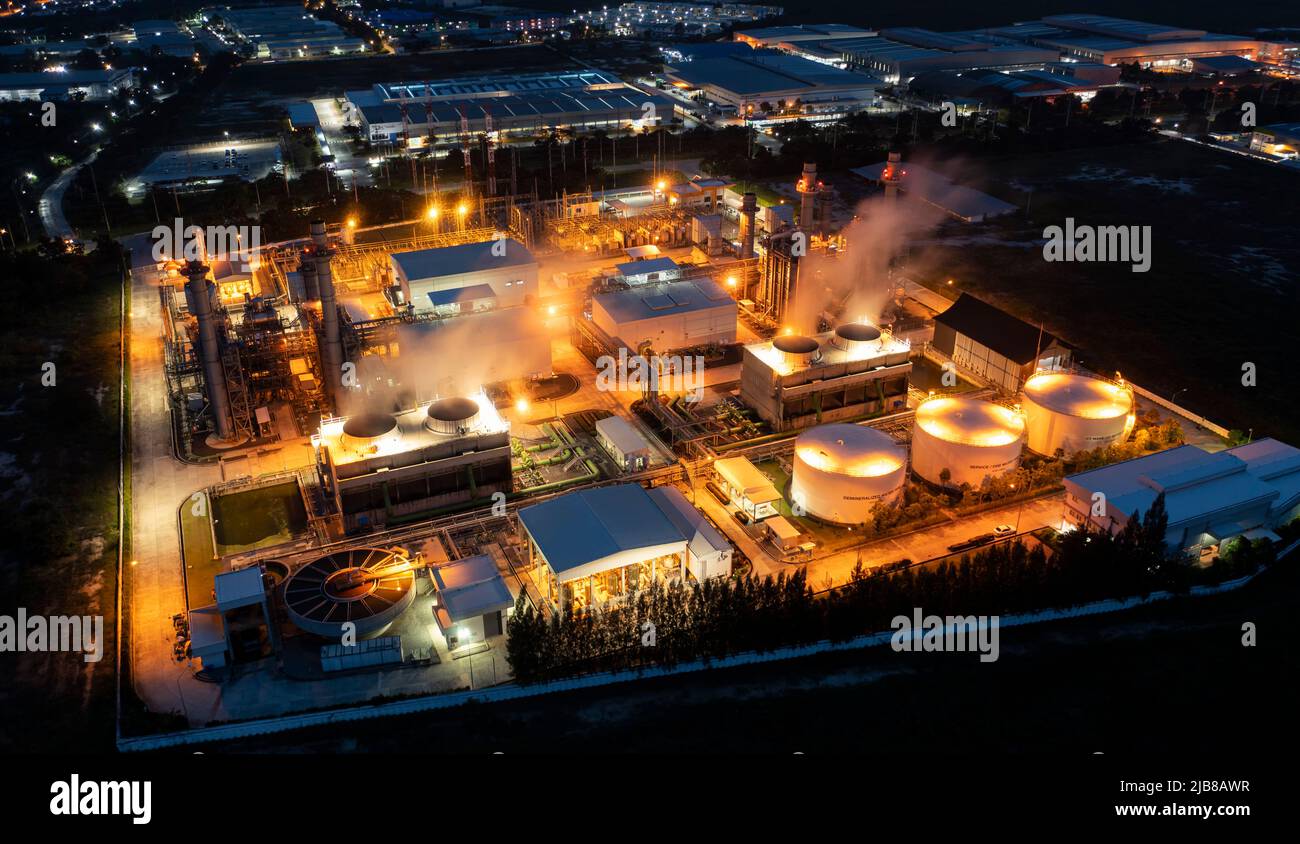 Aerial view drone of oil storage tank with oil refinery factory industrial. Oil refinery plant at beautiful sky sunset and twilight. industry factory Stock Photo