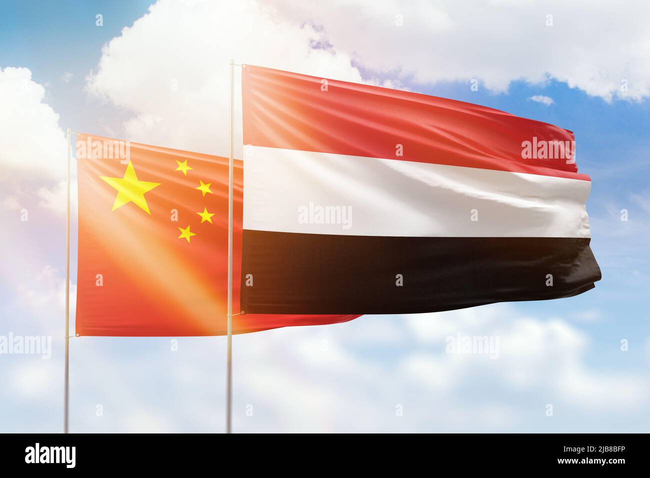 Sunny blue sky and flags of yemen and china Stock Photo Alamy