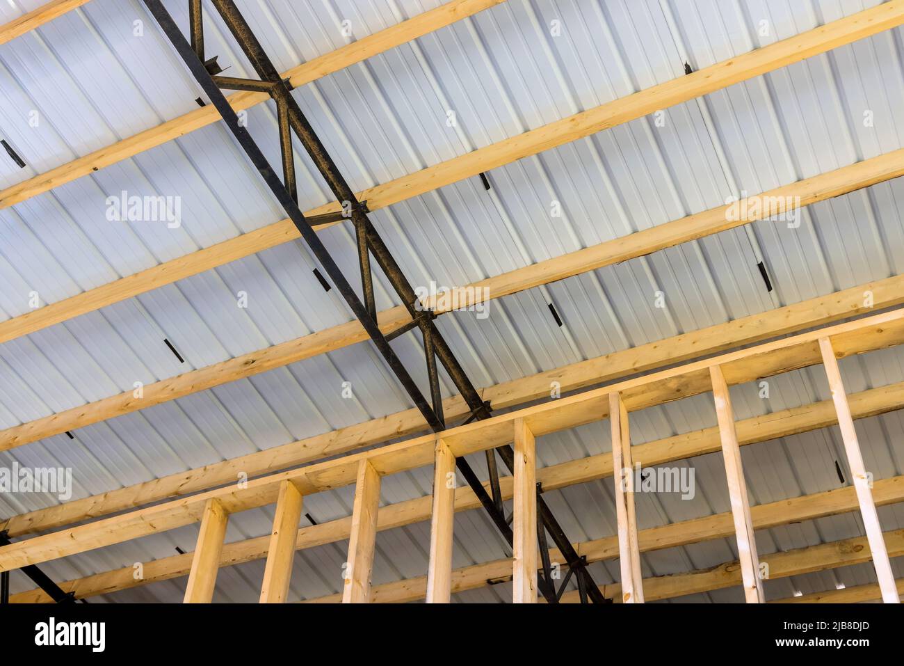 Roofing structure a large hangar consists of steel frame timber joists Stock Photo