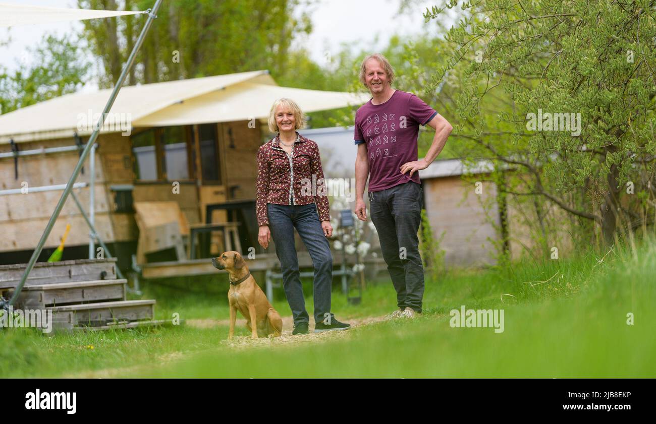 Hitzacker, Germany. 03rd May, 2022. Eva and Holger Danneberg, creators and  owners of the destinature village, stand in the destinature village. Mini  wooden cottages invite you to spend the night, and a