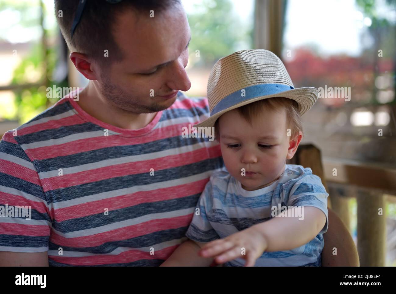 Father holding his cute little boy with the hat Stock Photo
