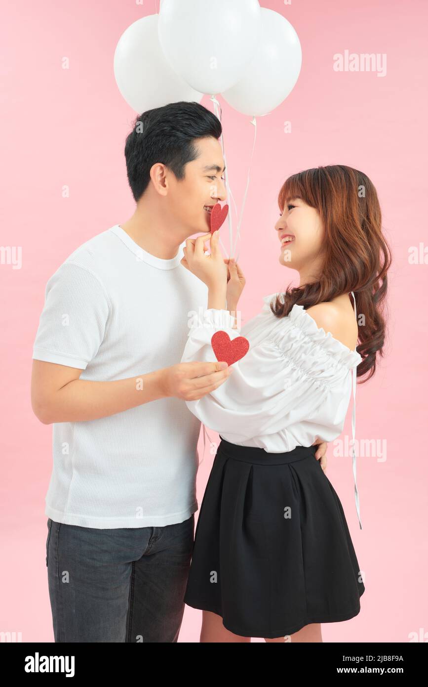 young happy couple embracing and holding heart shaped balloon Stock ...