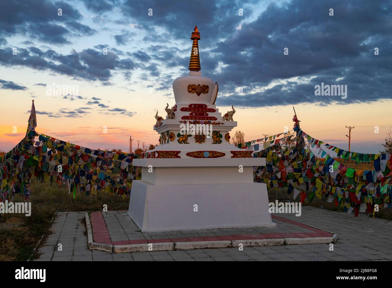 ELISTA, RUSSIA - SEPTEMBER 20, 2021: Buddhist sacred stupa of Syakyusn-sume temple against the backdrop of September sunset Stock Photo