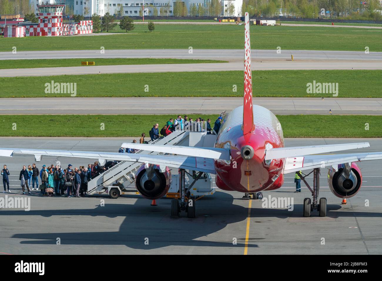 SAINT PETERSBURG, RUSSIA - MAY 20, 2022: The queue for boarding on aircraft Airbus A319-100 (RA-73212) of Rossiya airlines on the airfield of Pulkovo Stock Photo