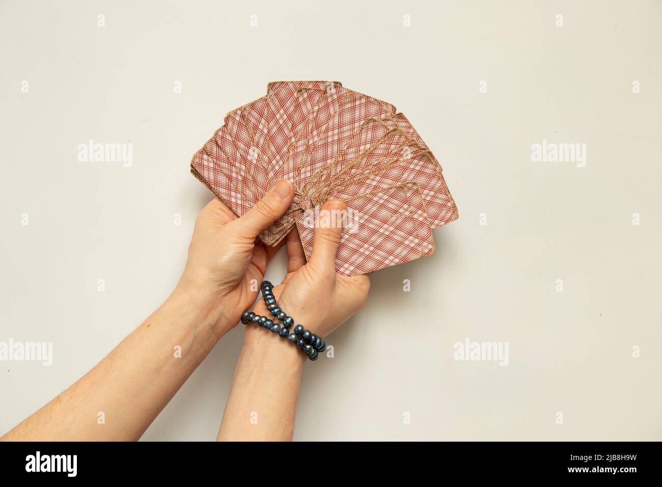 fortune-telling cards in the hands of a girl, a layout on cards for predicting fate by cards Stock Photo