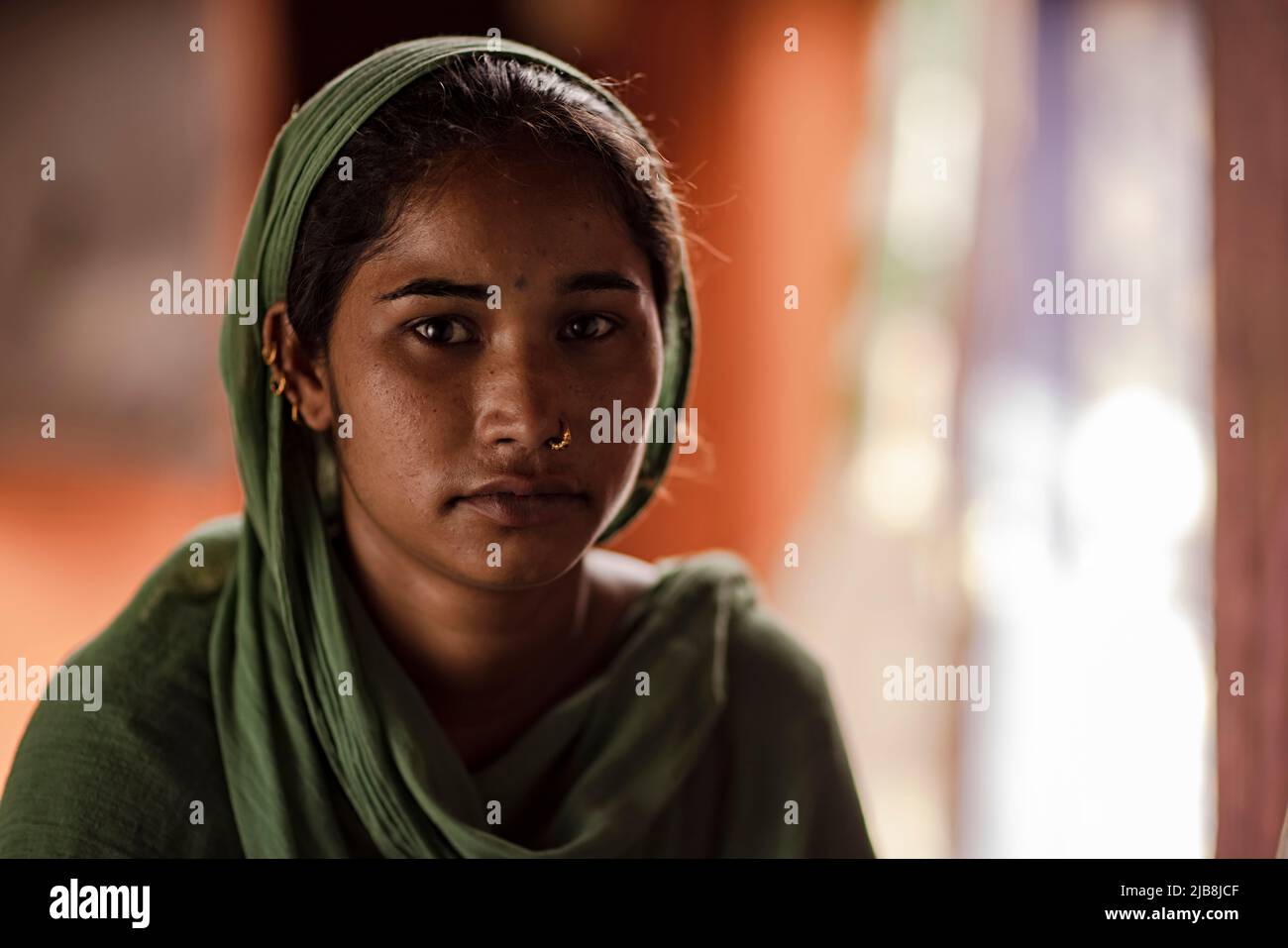 Portrait of a slum young woman at home Stock Photo